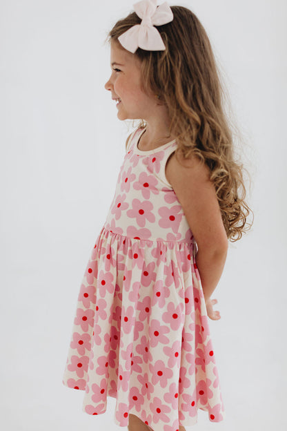 Pink floral twirl dress with scoop neckline and gathered skirt, side view