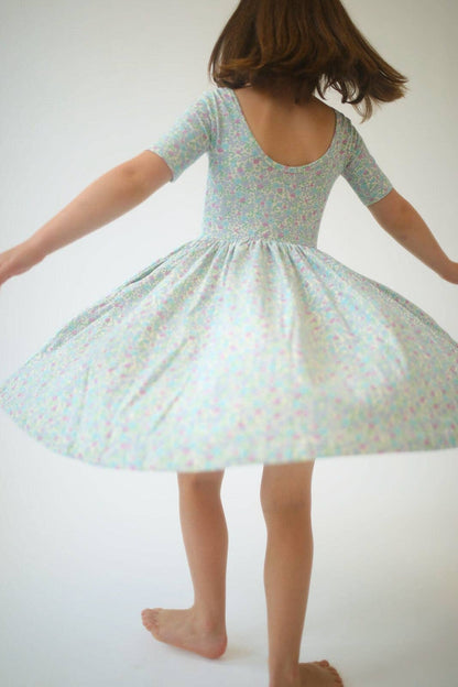 Girls green floral twirl dress, back view, short sleeves and flared skirt