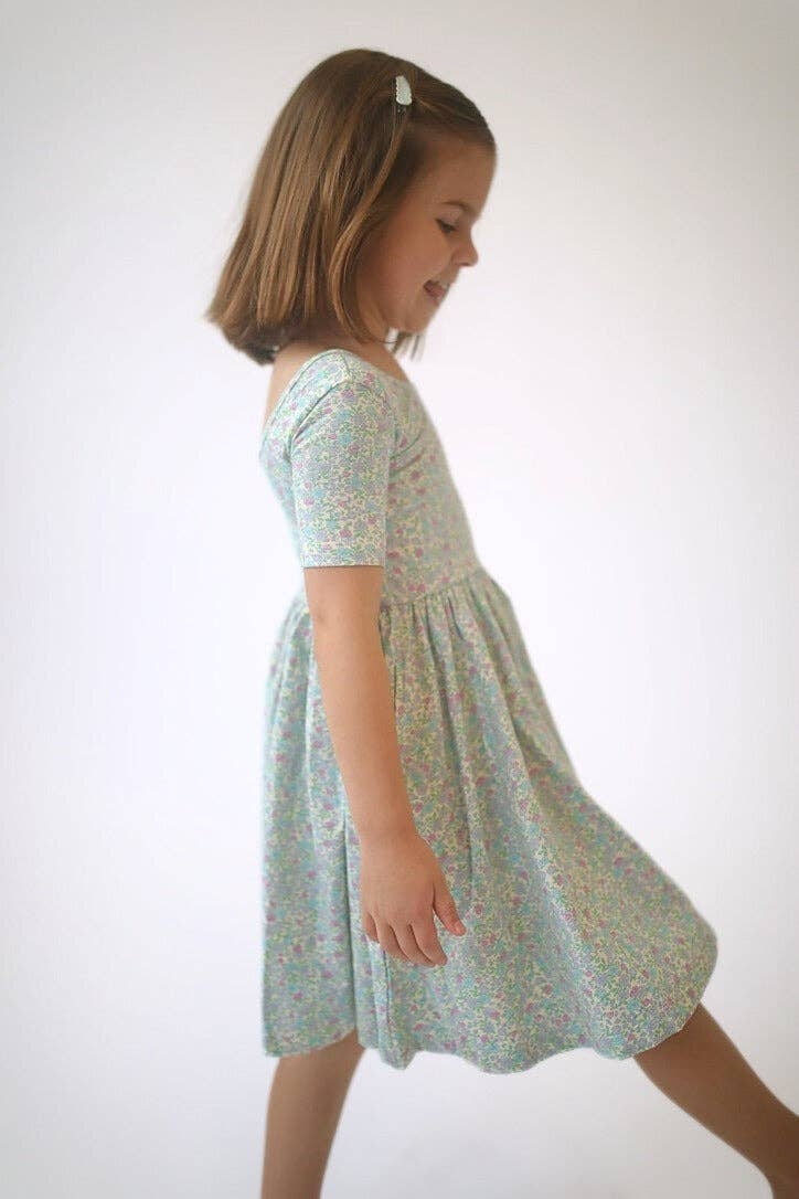 Girls green floral twirl dress, side view, gathered waist and flared skirt