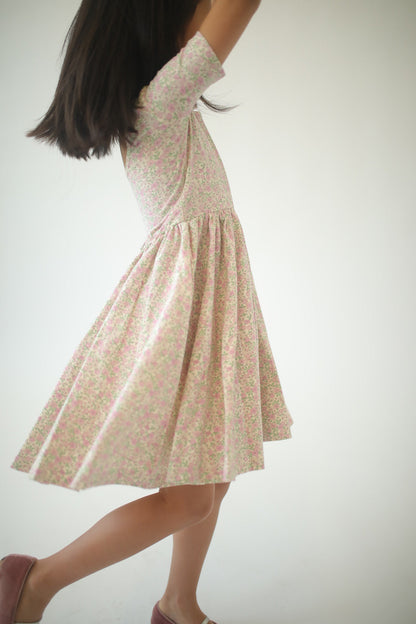 Girls twirl dress in pink speckled floral print, twirly A-line skirt, back view.