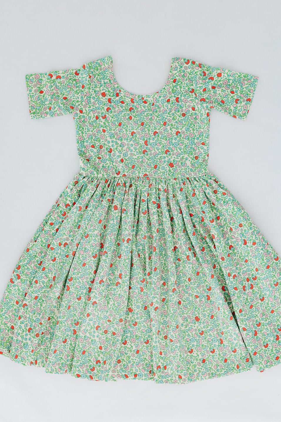 Girls green floral twirl dress, front view, off-shoulder square neckline