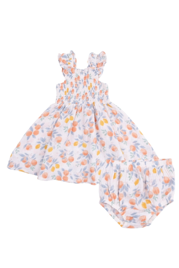 Smocked sundress and bloomers set with orange floral print, ruffled shoulders.