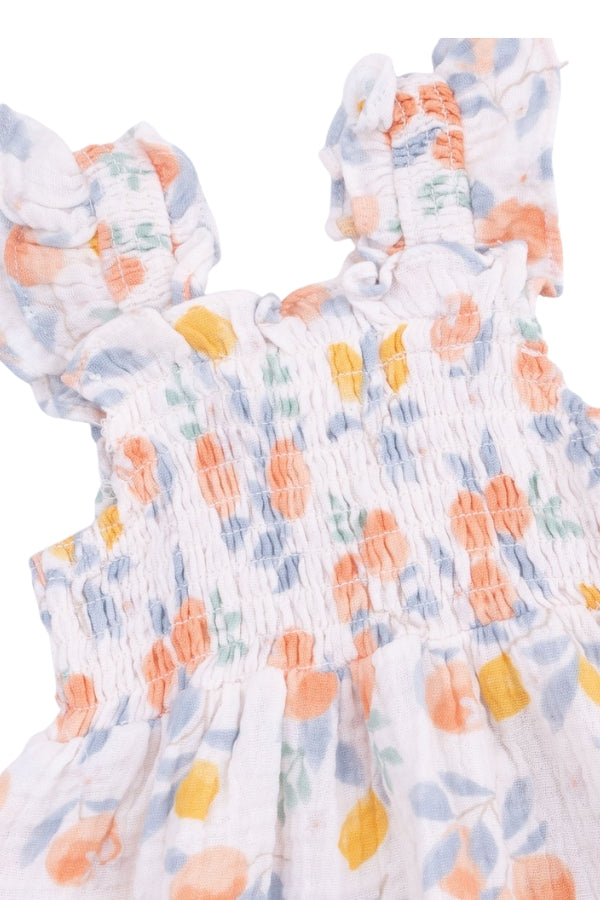 Smocked sundress bodice close-up with multicolor floral print and gathered detailing.