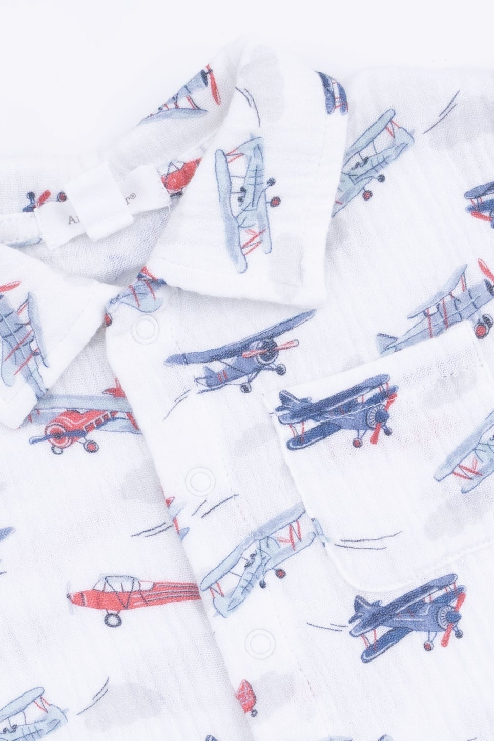 White printed plane button-up shirt with short sleeves and front buttons