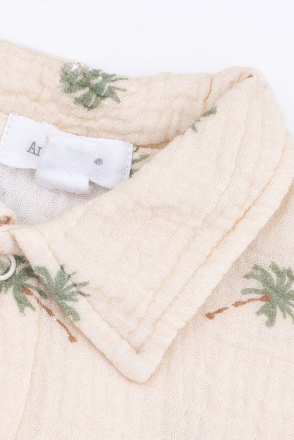 Palm print polo button-up collar detail on cream fabric