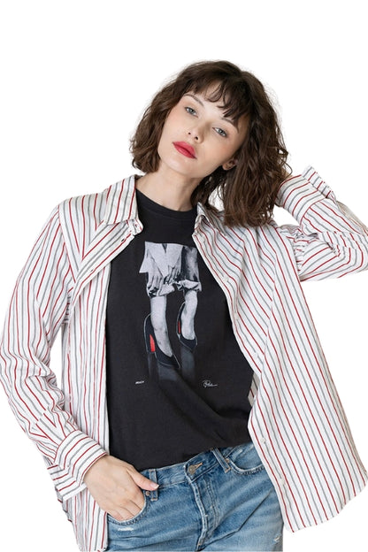 Woman wearing a striped shirt over a graphic t-shirt on a white background