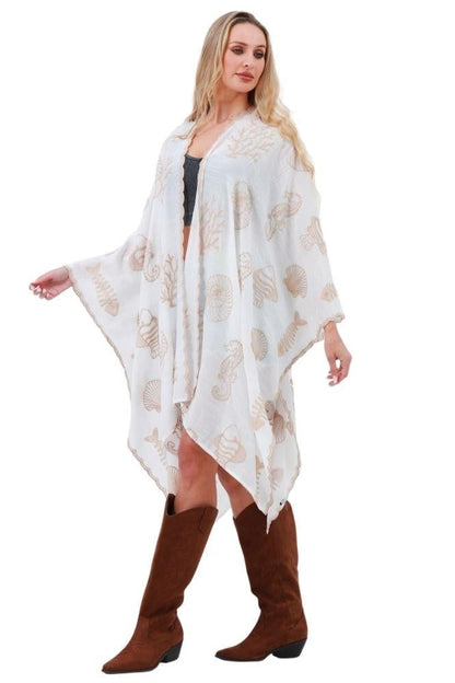 White kimono with wide sleeves, shell and seahorse embroidery motifs