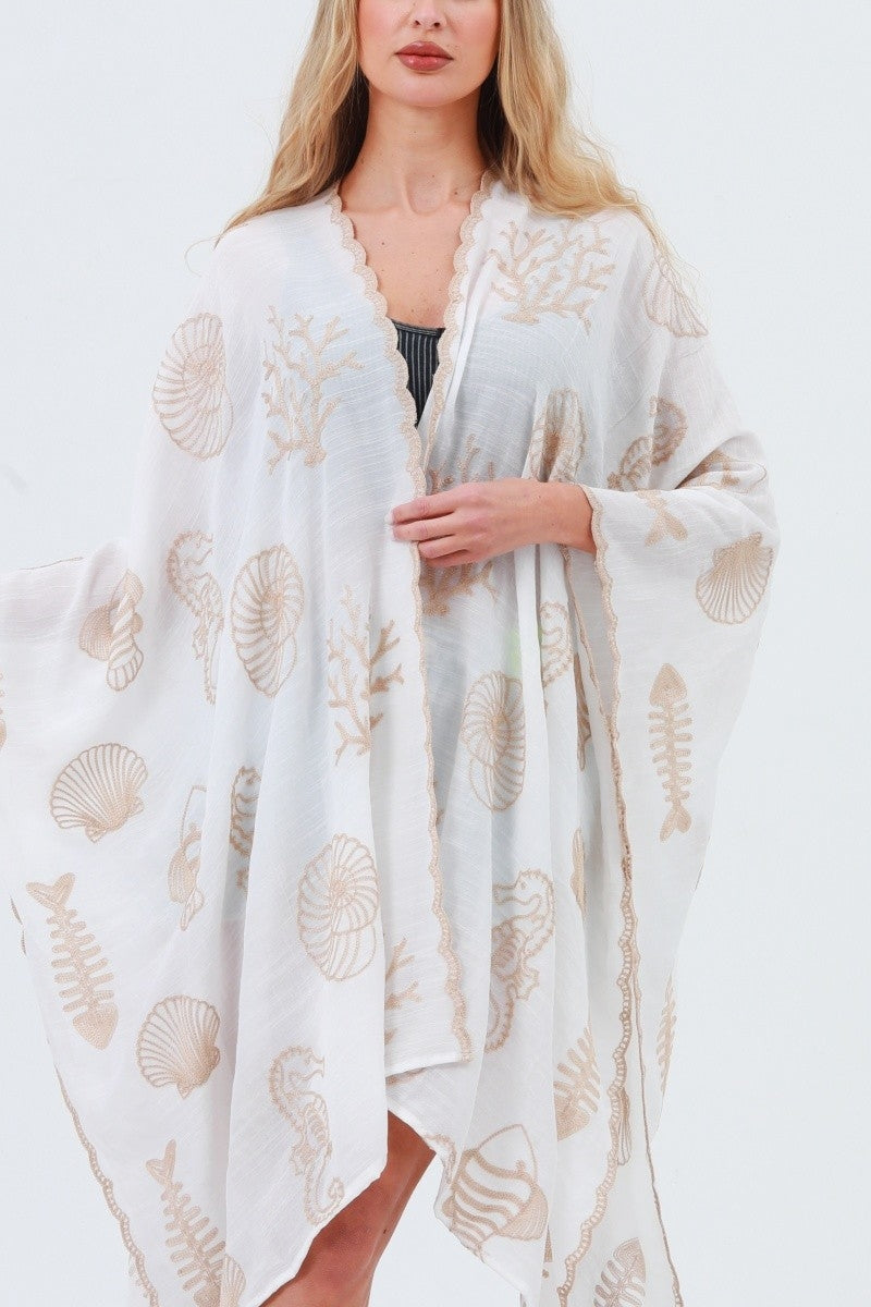 White kimono with shell and seahorse embroidery, open front, scalloped trim at edges