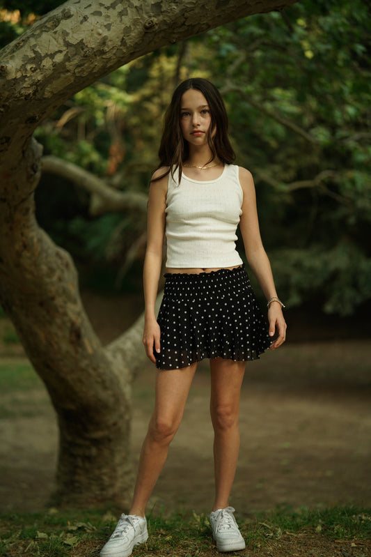 Black mesh skort with white dot pattern, gathered waistband and pleated skirt