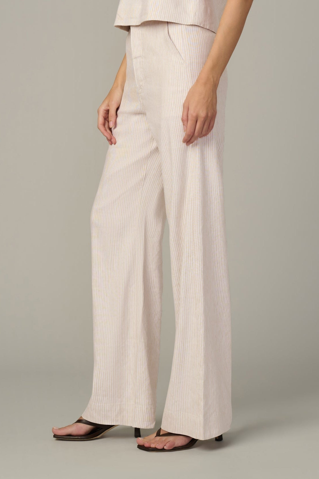 Cream micro-stripe wide-leg trousers with side pleats and relaxed straight hem