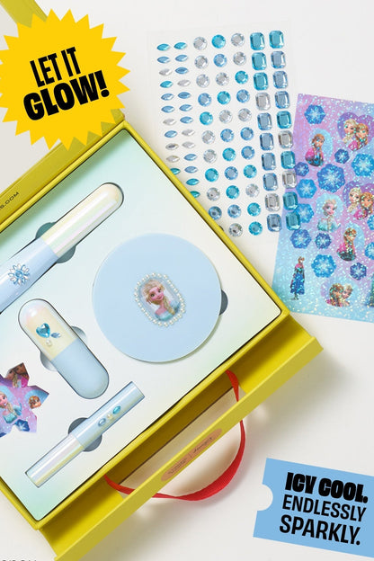 Frozen Elsa makeup kit open with brush, lip balm, and glitter sticker sheet