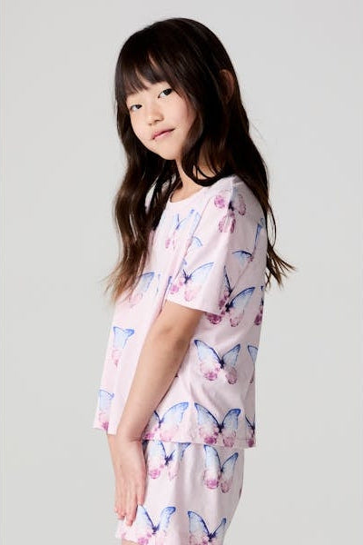 Girls' pink butterfly print tee shown from the side, blue and pink butterfly pattern