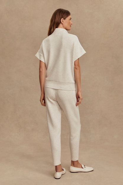 Ivory marl slim pants, back view with tapered legs and cuffed hem