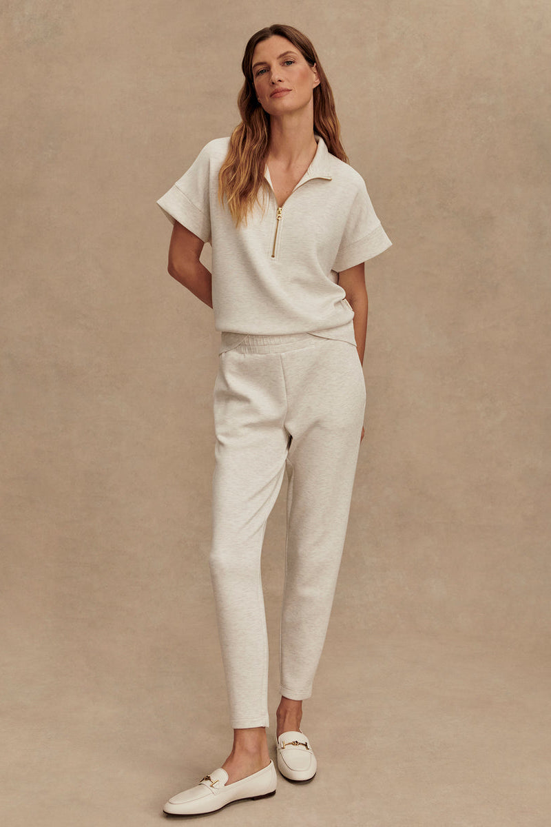 Ivory marl slim pants with elastic waist, tapered fit, cuffed hem and side pockets