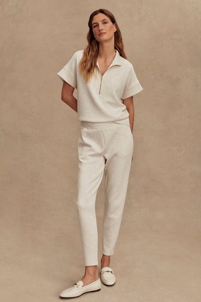Ivory marl slim pants with elastic waist, tapered fit, cuffed hem and side pockets