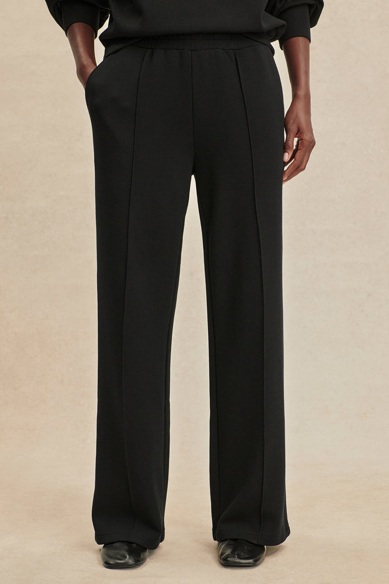 Black wide-leg pants with elastic drawstring waist and relaxed straight legs