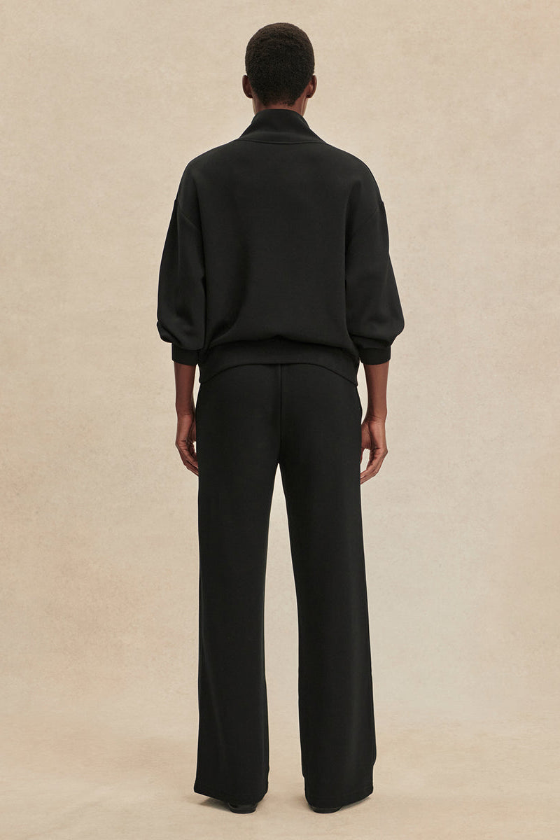 Black wide-leg pants with elastic waistband and straight wide legs, back view