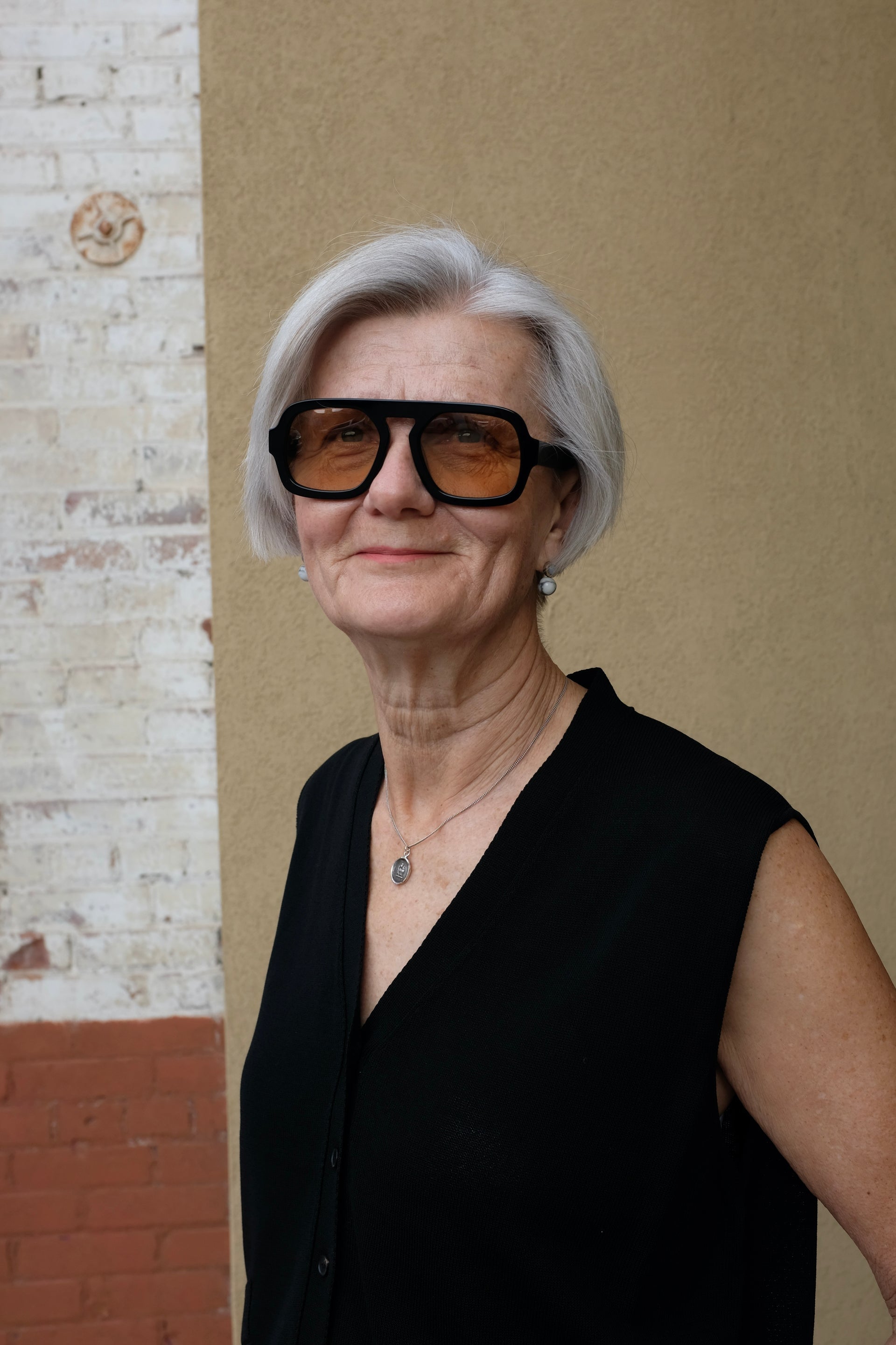 Black oversized sunglasses with rectangular frames on a woman