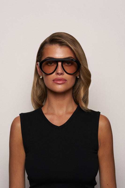 VAL sunglasses on model, dark lenses and black frame with thin arms