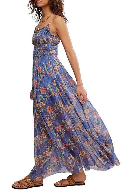 Woman wearing a blue floral maxi dress on a white background