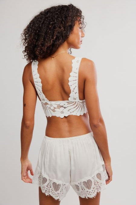 Clean ivory lace plunge bralette with open back scallops and adjustable straps