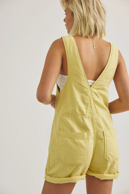 Sleeveless yellow shortall back view with open V yoke and patch pockets