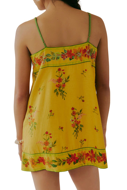 Yellow floral mini dress with green spaghetti straps, back view