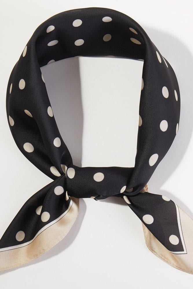 Black polka dot bandana with small white dots, square scarf with tied ends