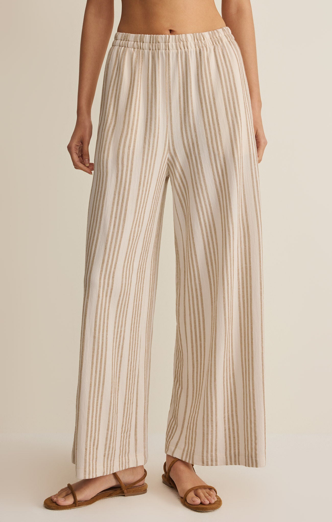 Striped knit wide-leg pants with elastic waistband, tan vertical stripes on light fabric