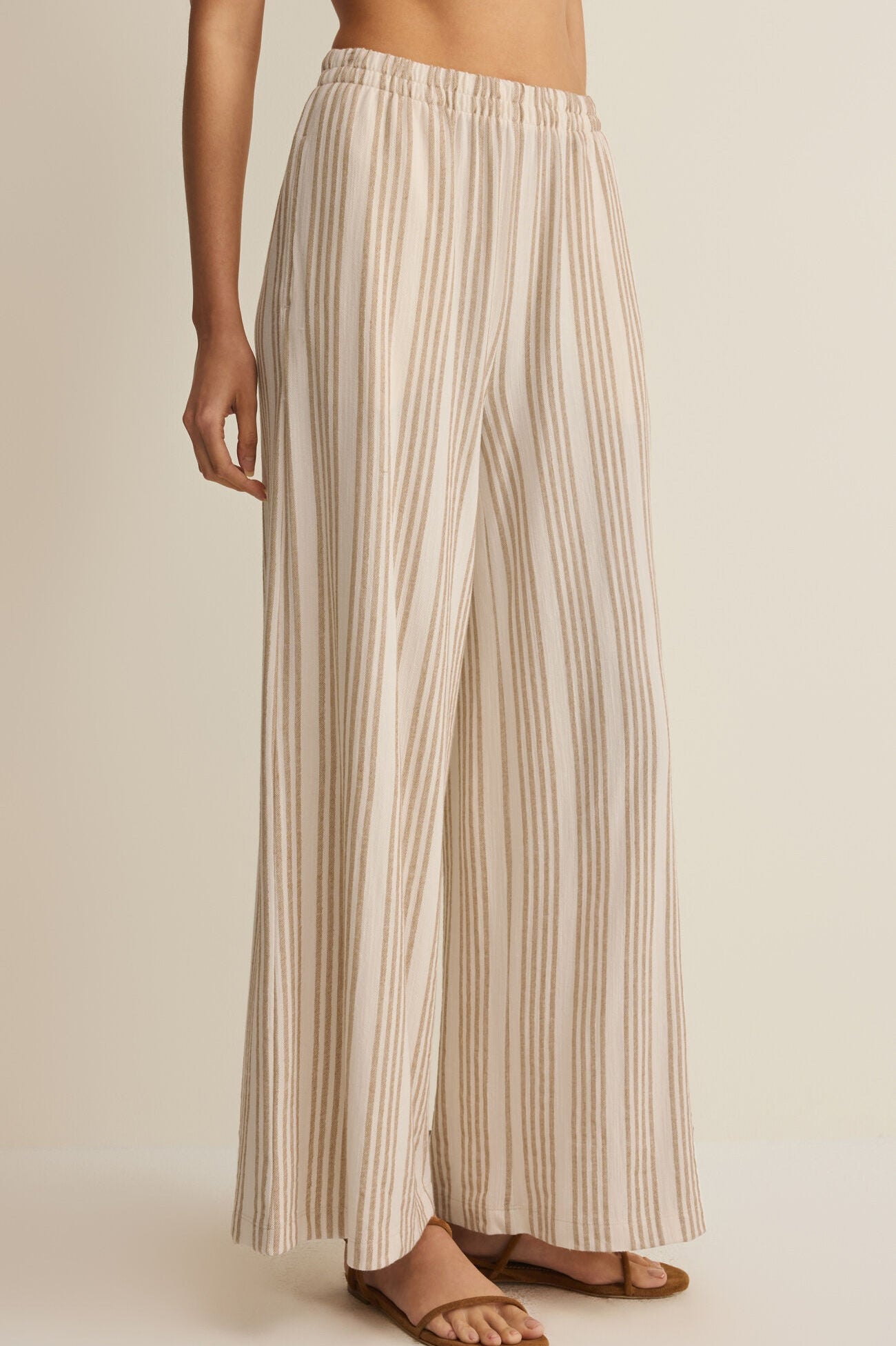 Striped knit wide-leg pants with elastic waistband, tan vertical stripes on light fabric