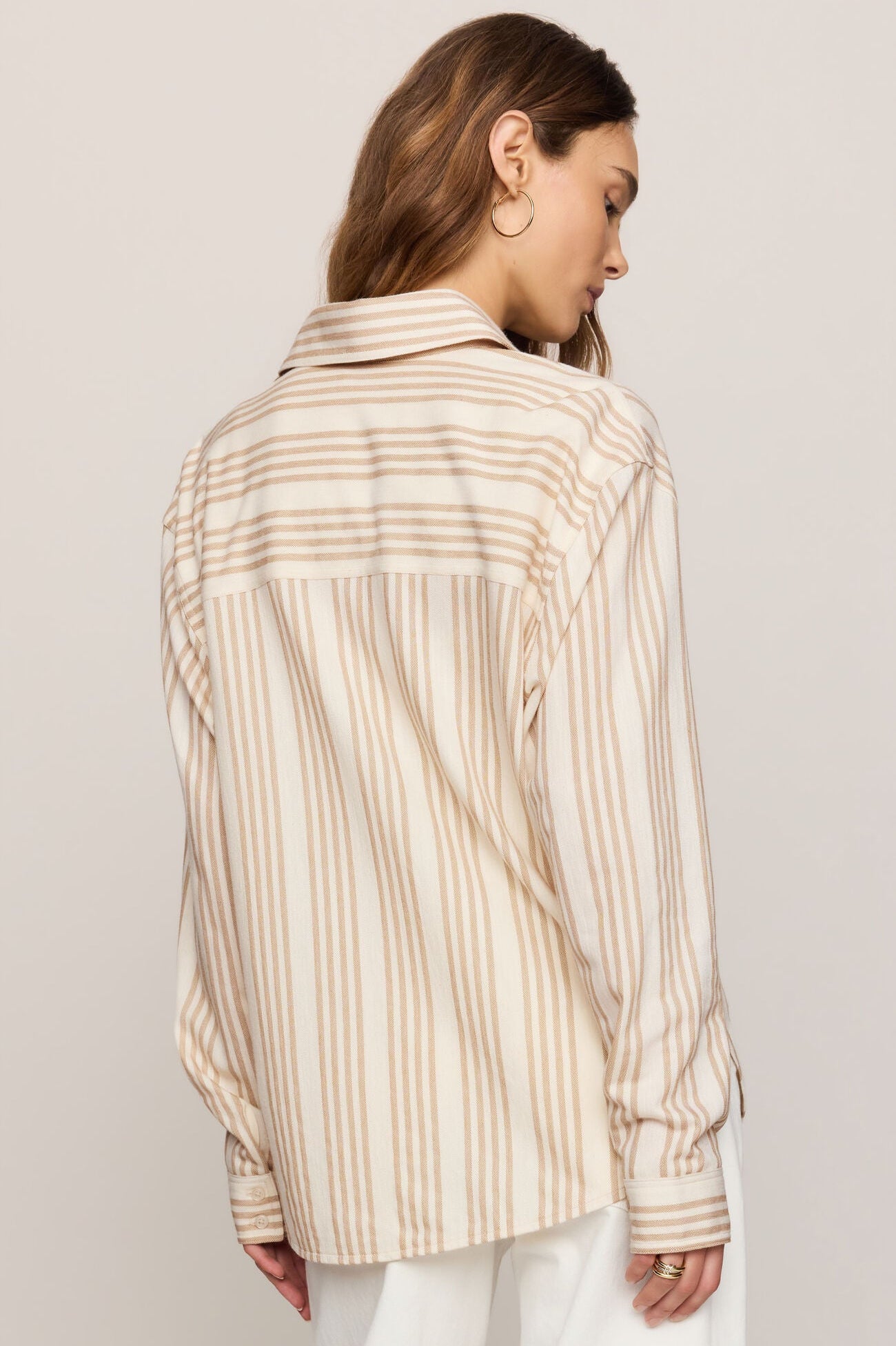 Striped button-up shirt back view with long sleeves and gathered cuffs