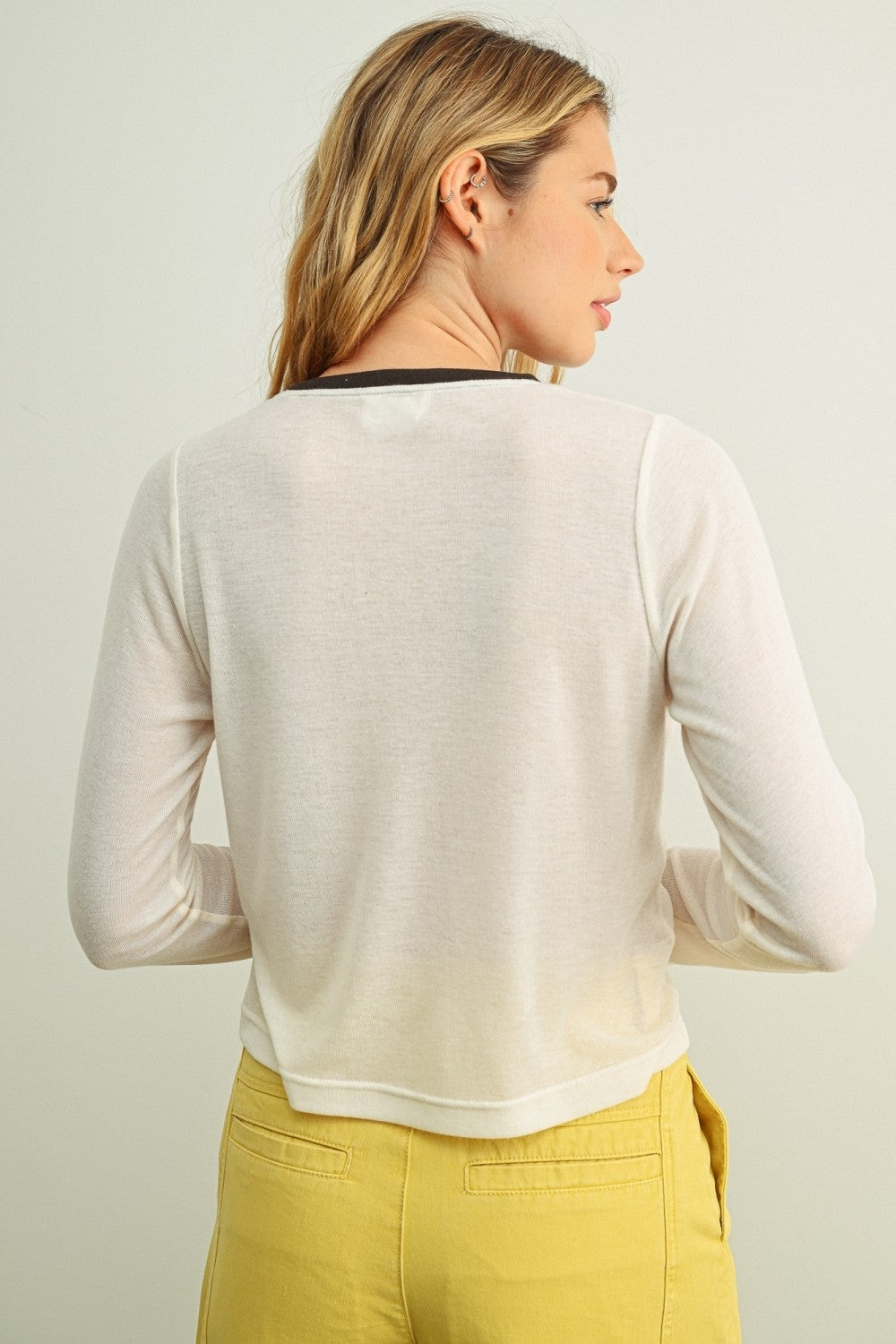 Cream ringer long-sleeve top with contrast navy neck trim, back view