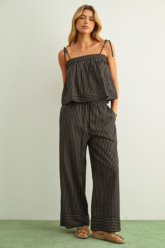 Wide-leg striped pants, black with white pinstripes, cuffed hem with border