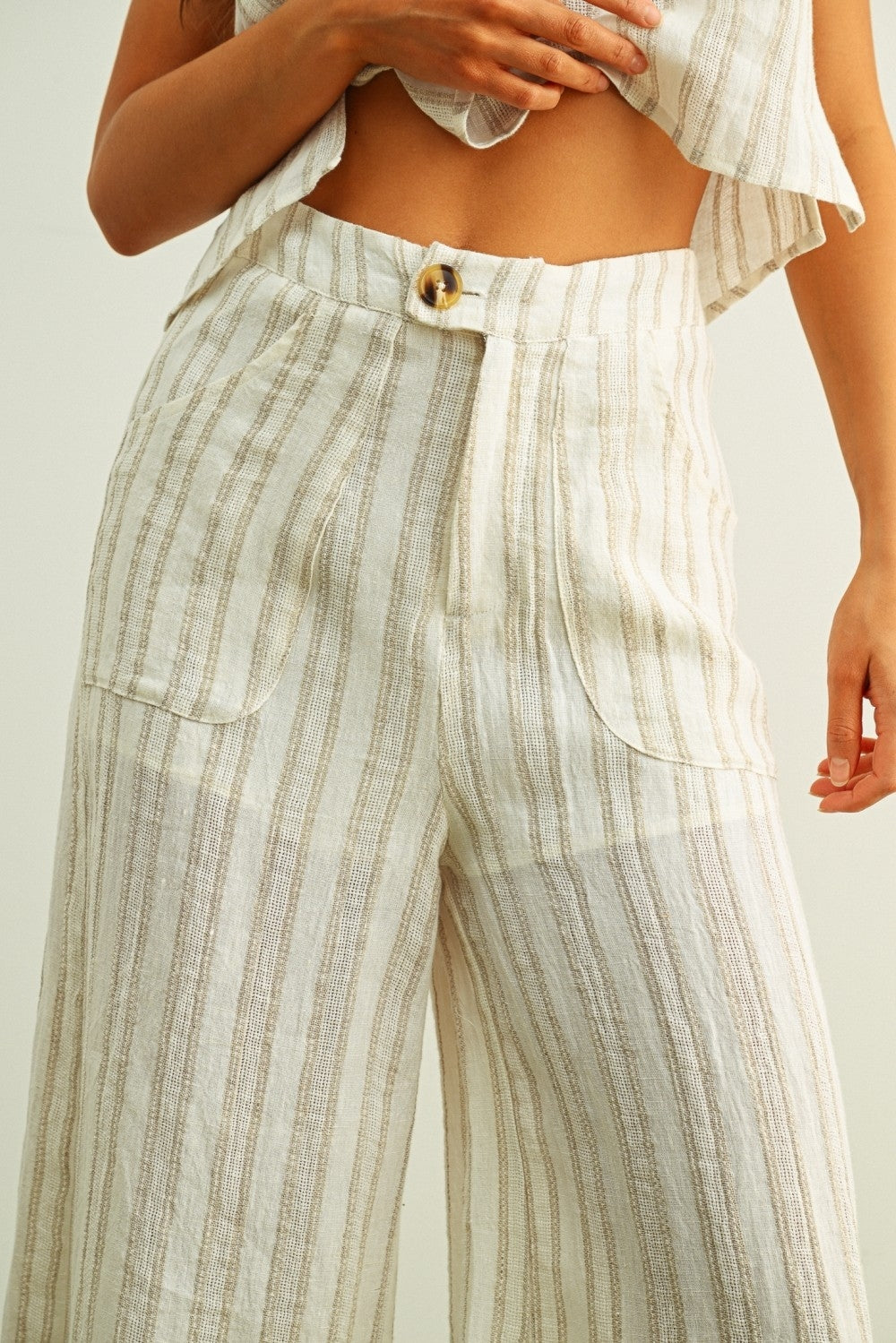 High-waist linen pants with front button and patch pockets, stone vertical stripes