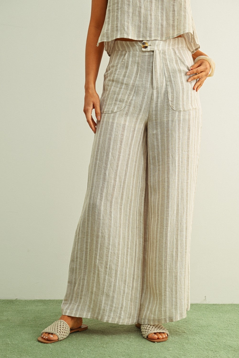 High-waist linen pants in stone vertical stripes, button closure, side patch pockets