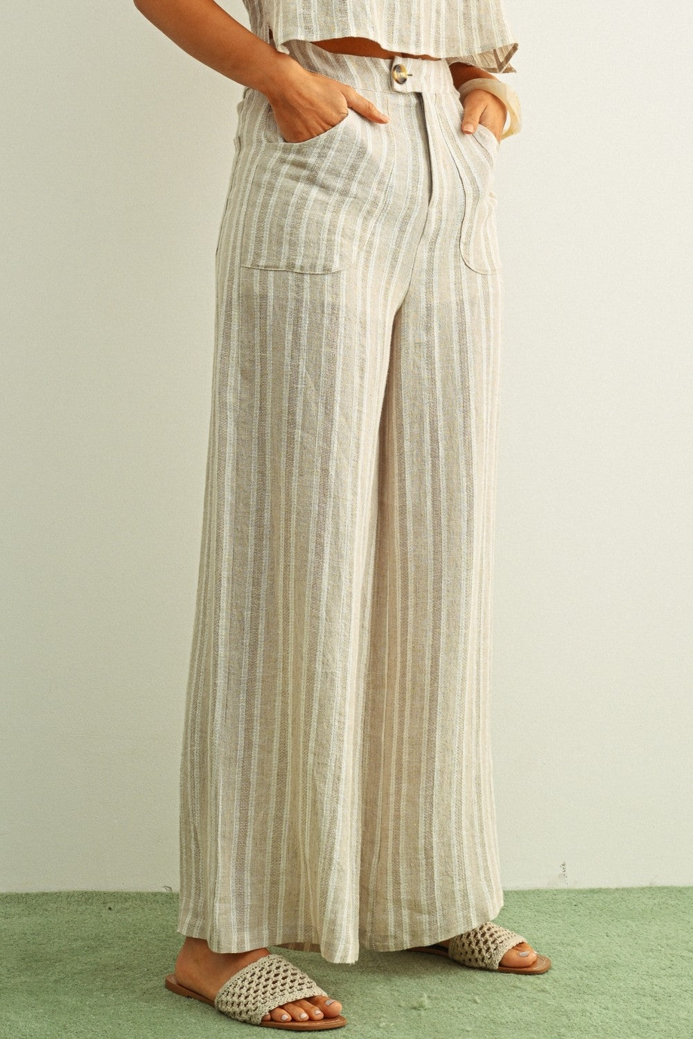Linen wide-leg pants with front button and patch pockets, vertical stone stripes