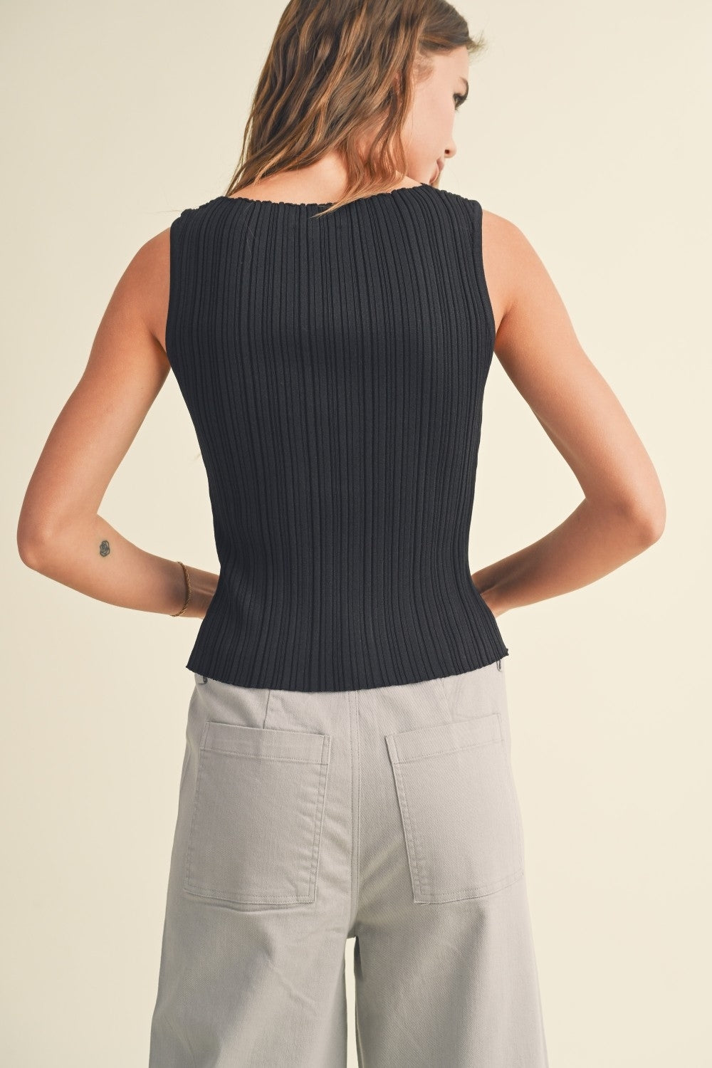 Black ribbed knit sleeveless top with crew back and vertical rib texture