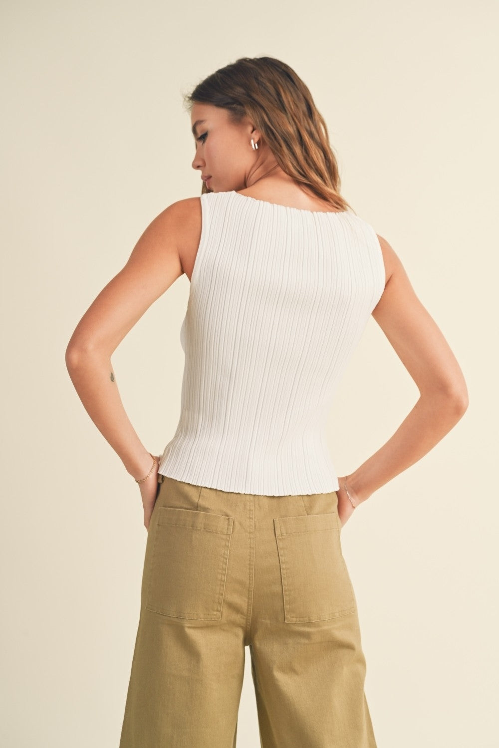 Off white ribbed knit sleeveless top with racer back and vertical ribbed texture