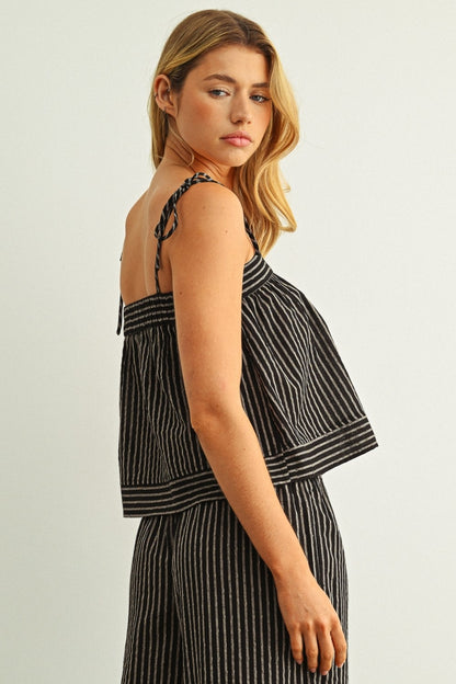 Dark striped print tank top side view with spaghetti straps and ruffled hem