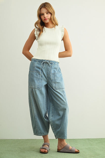 Off-white ribbed knit top with ruffle sleeves
