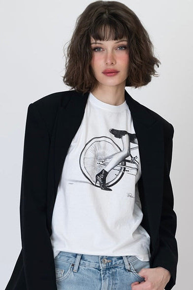 Worn white graphic t-shirt with cyclist and bicycle wheel print