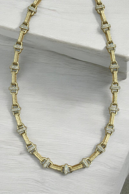 Gold-tone chain necklace with rectangular link settings and clear crystal spacers