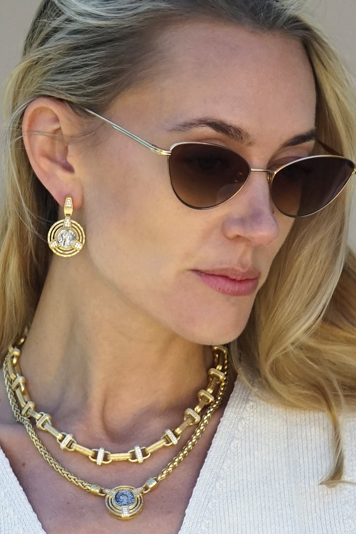 Gold-tone chain necklace with blue center charm and small clear crystal accents