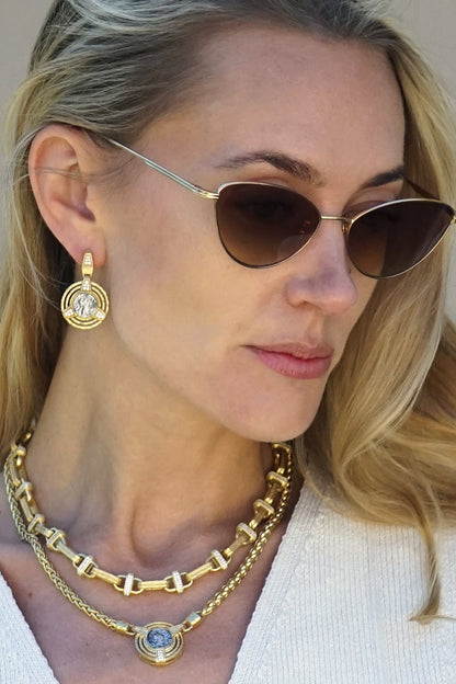 Gold-tone chain necklace with blue center charm and small clear crystal accents