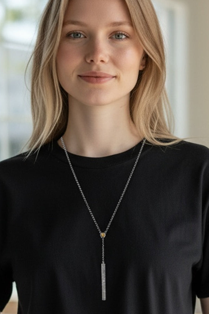 Hammered lariat necklace worn on model, round charm with long rectangular pendant