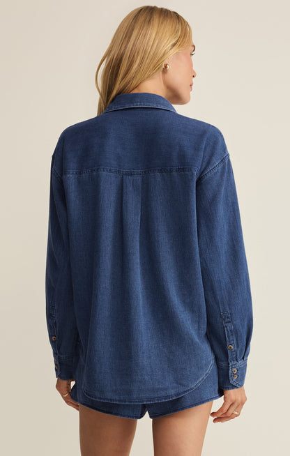 Blue twill button-up shirt back view, yoke seam and two buttoned cuffs