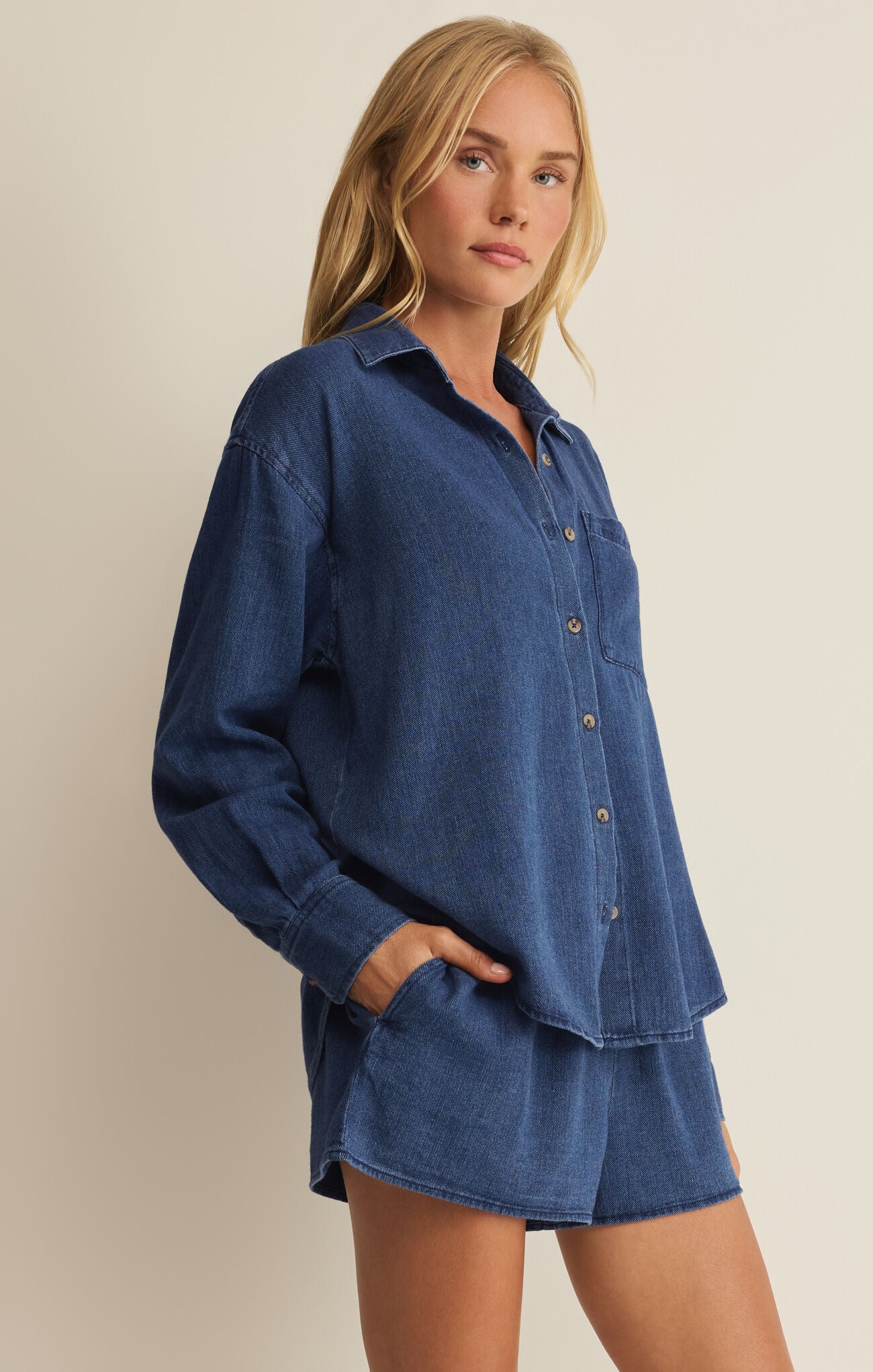 Blue twill button-up shirt with pointed collar and button placket, cuffed sleeves