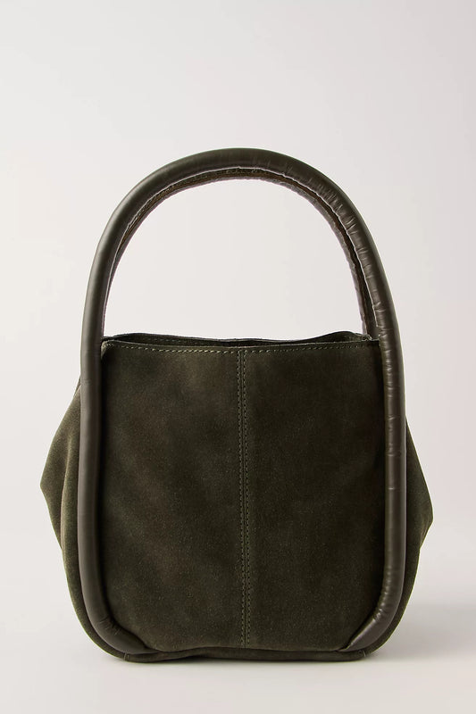 A dark olive green suede handbag with a unique curved top handle, photographed against a neutral light gray background.