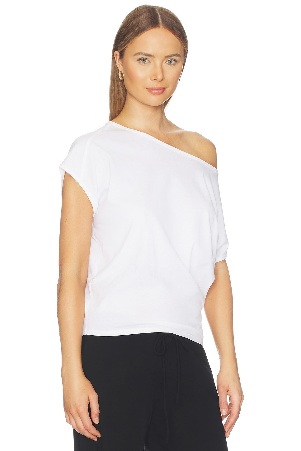 Woman wearing a white one-shoulder top on a white background