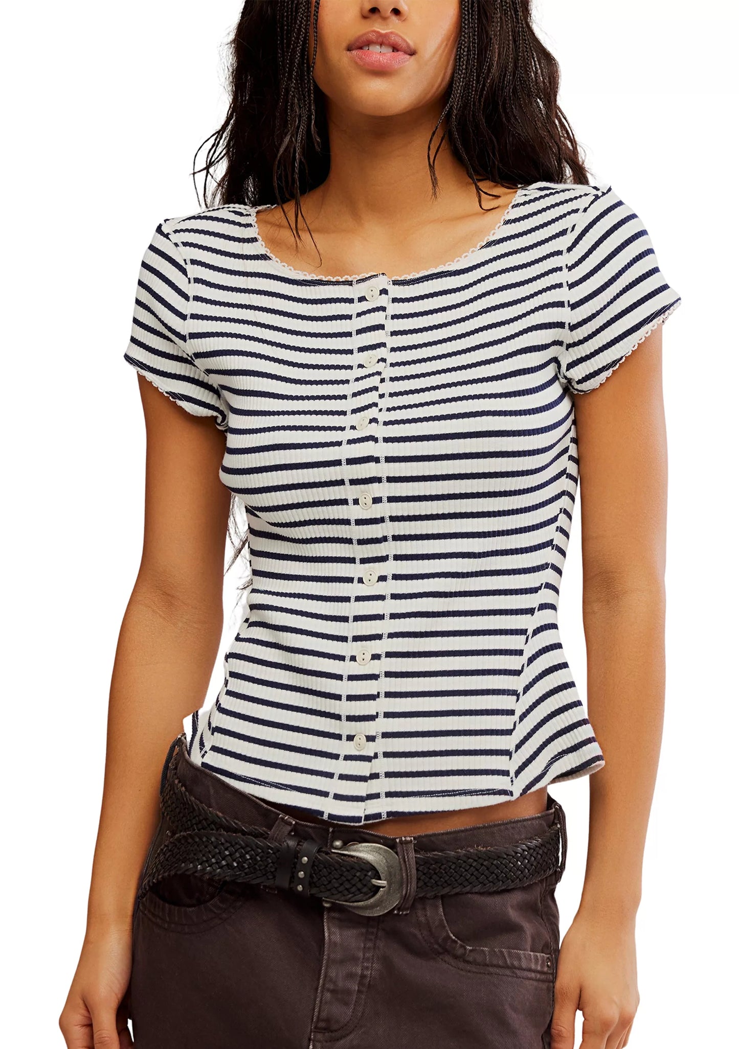 Woman wearing a black and white striped shirt with a plain background